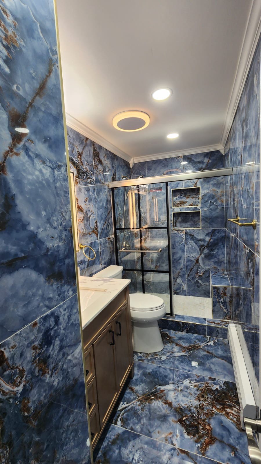 Luxury blue marble bathroom renovation by Stunning Finish Corp